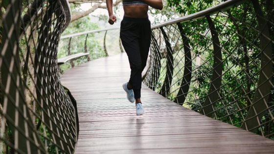 woman running along bridge trail