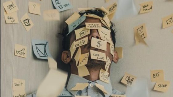 sticky notes on man's face and wall