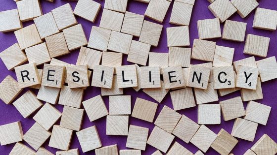 wood scrabble letters spelling resiliency